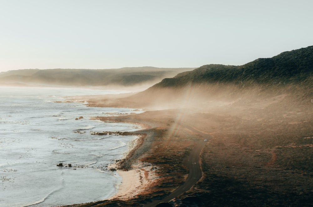 ocean waves crashing on shore during foggy weather