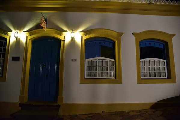 Lamplit doors and windows on a colonial house at night — Tiradentes, Brazil