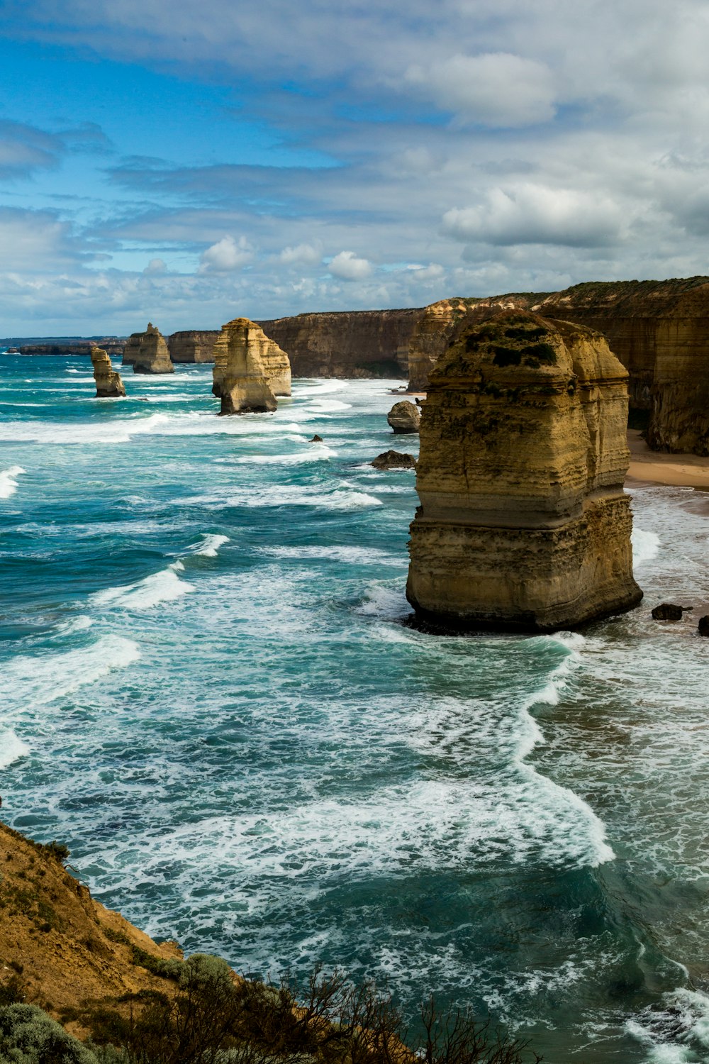 brown rock formation on sea during daytime