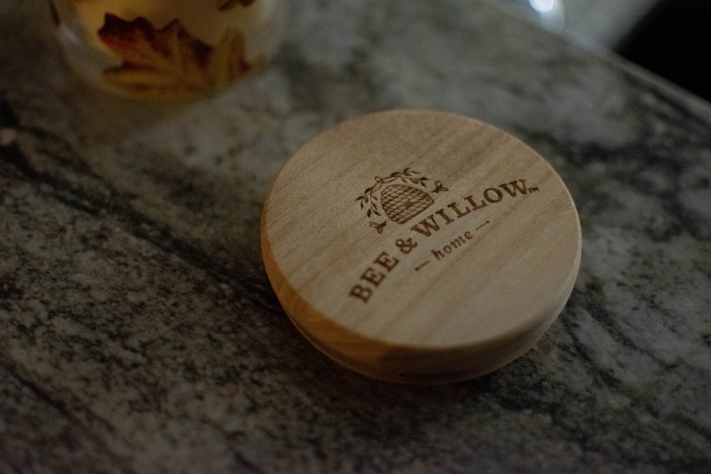 brown wooden round container on black and gray marble table