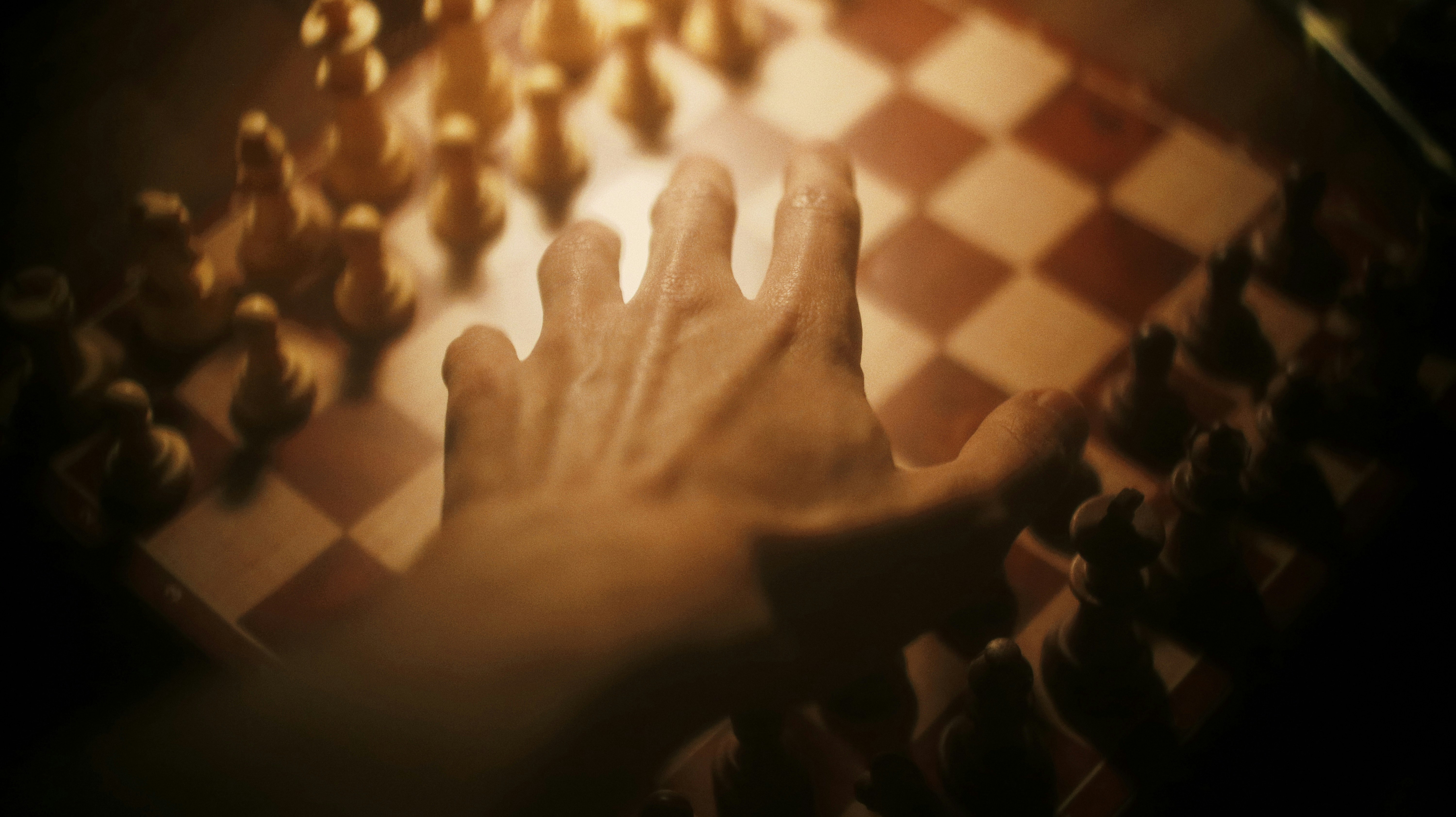 persons hand on brown and white textile