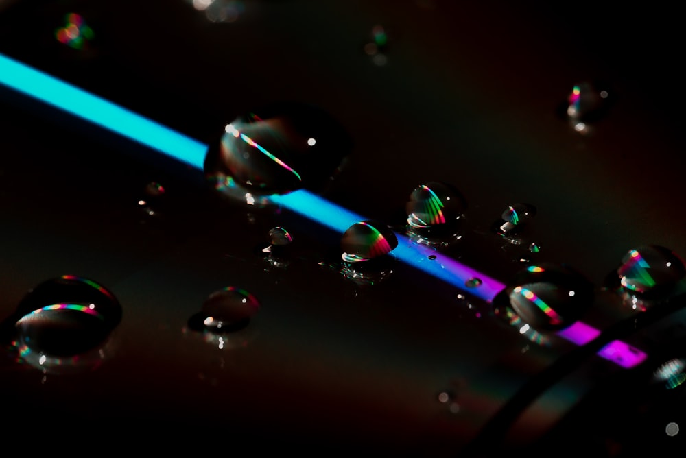 a group of bubbles floating on top of a black surface