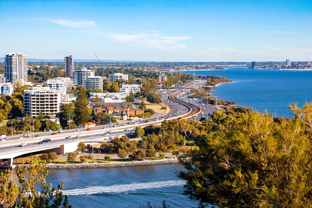 aerial view of city buildings near body of water during daytime