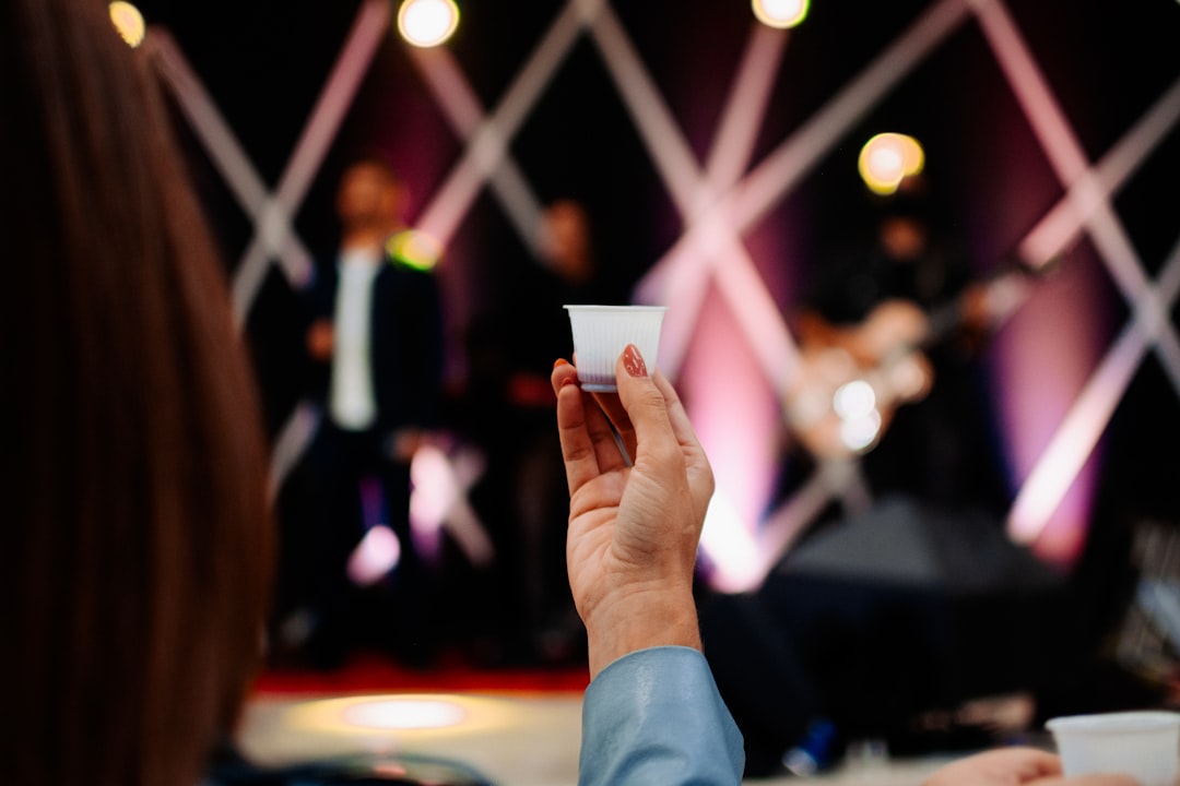 person in blue long sleeve shirt holding white card