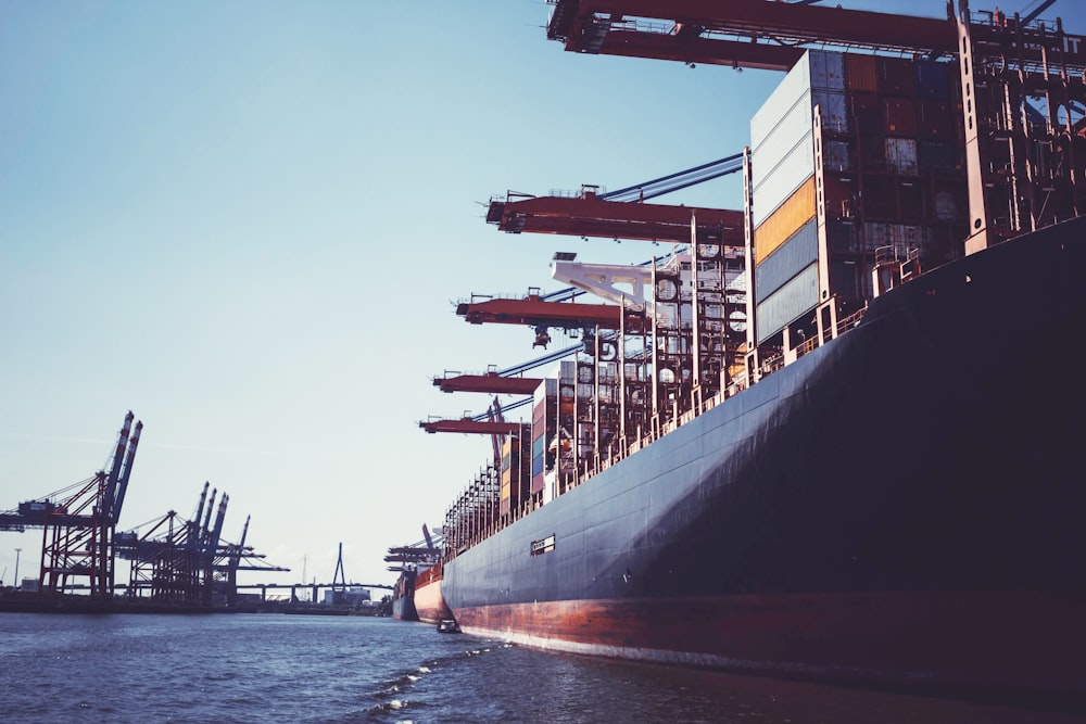 black and red ship on sea during daytime