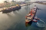 red and blue cargo ship on body of water during daytime