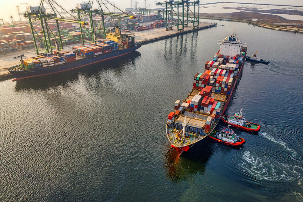 Cargo ships and tugboats in harbor