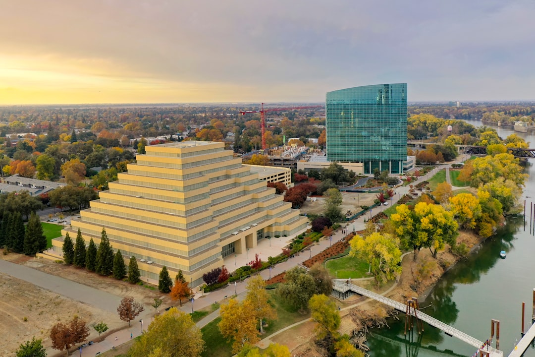 high rise building near green trees during daytime