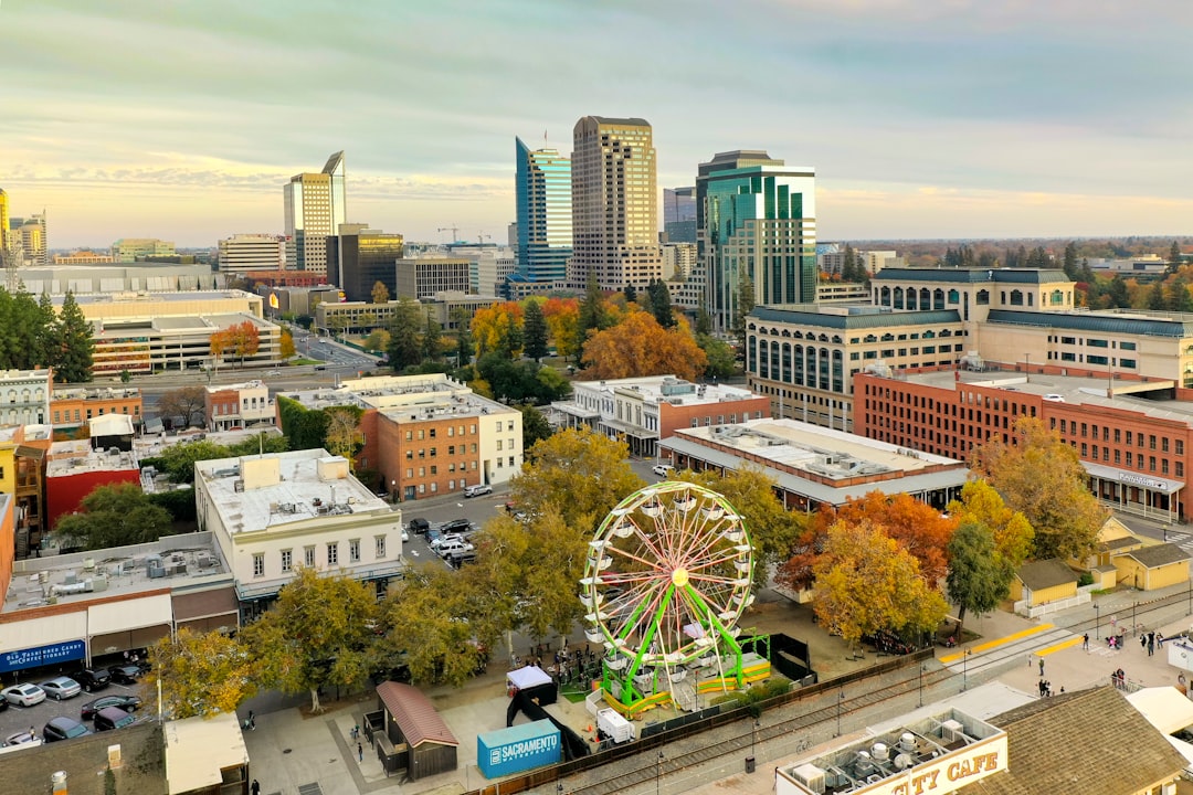 ferris wheel near city buildings during daytime