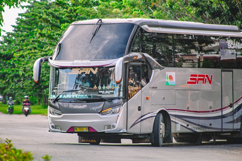 white and black bus on road during daytime