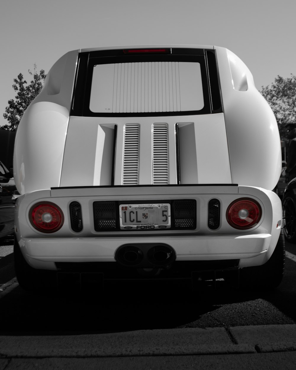 white and black car in a parking lot during daytime