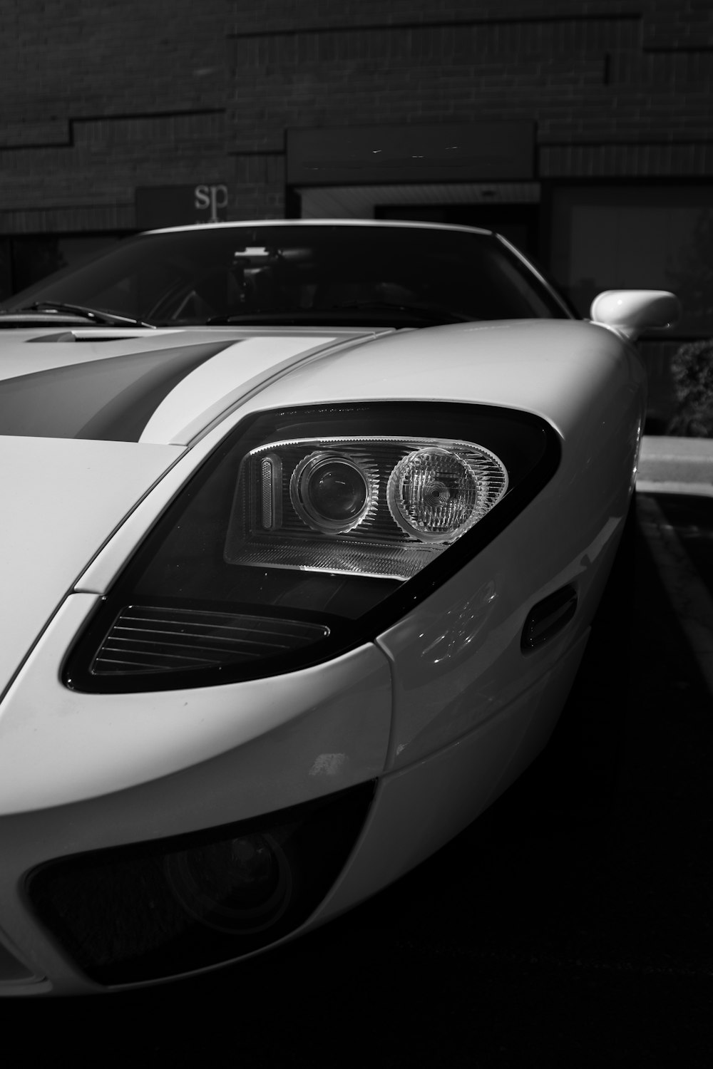 grayscale photo of car in a parking lot