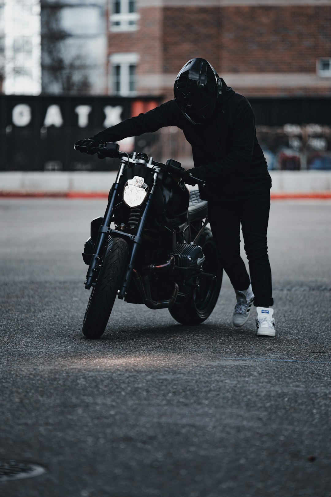 man in black jacket riding black motorcycle