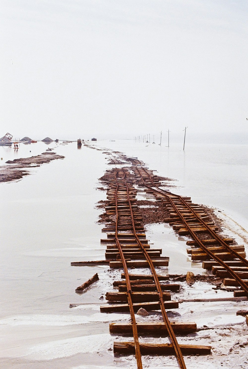 brown wooden fence on snow covered ground during daytime