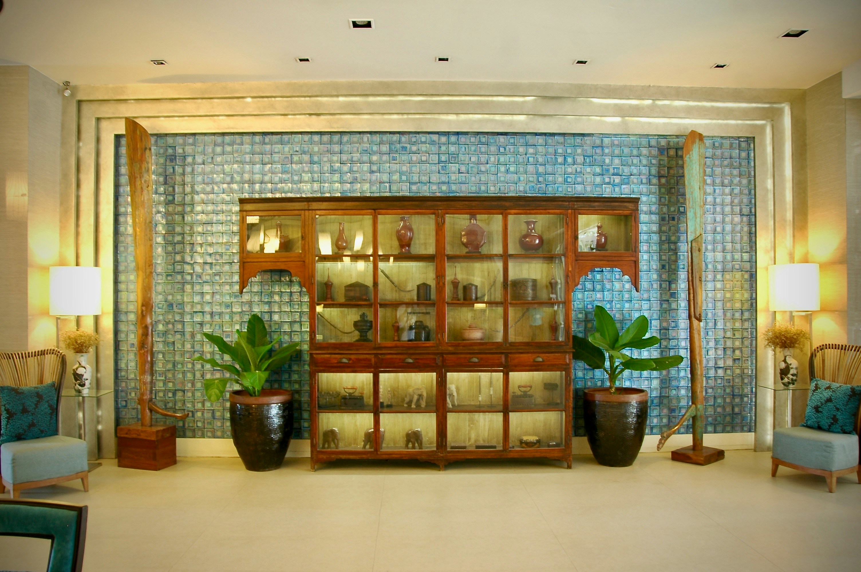 brown wooden glass cabinet with green potted plant