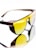 A pair of sunglasses with yellow tinted lenses and a dark brown frame. The design features perforated details on the frame corner near the temples. The reflective surface beneath them creates a mirrored effect, enhancing the visual impact.