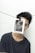 A person wearing a dark shirt appears to be partially covered by a monochrome photograph clipped to a line, obscuring part of their face. The photo has text saying 'It's okay not to be ok!' The background is plain white, and the line is strung horizontally across the image.