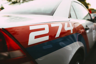 a red white and blue police car parked in a parking lot