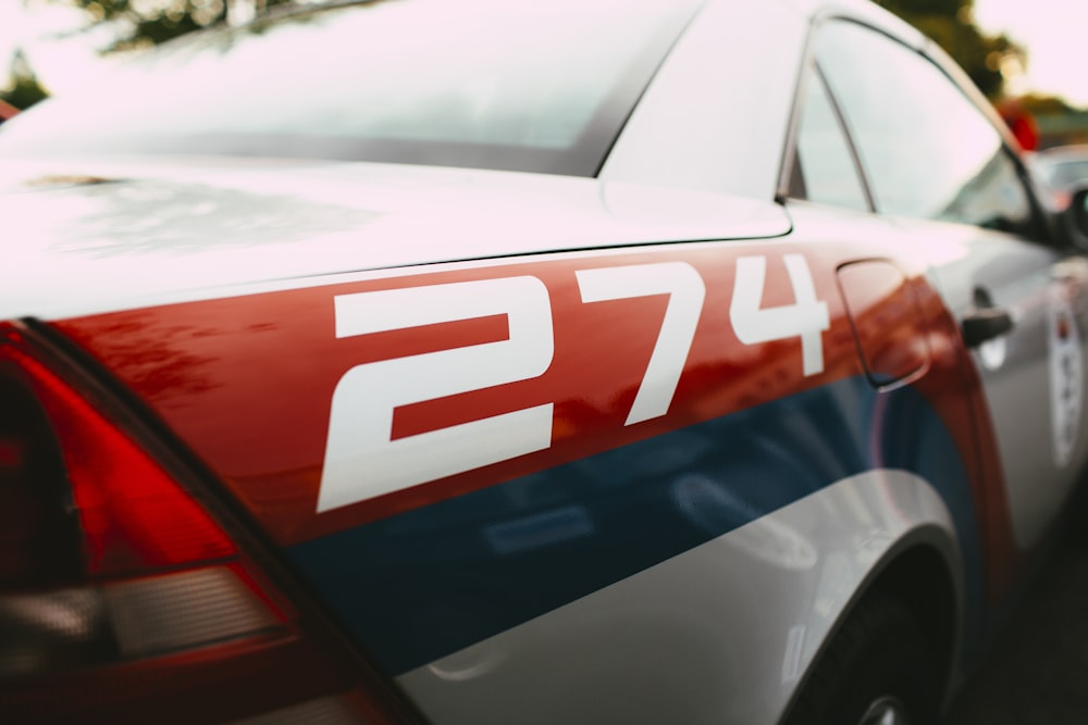 a red white and blue police car parked in a parking lot