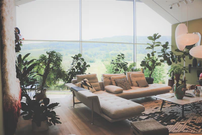 A cozy living room with large windows showcasing the rolling hills outside.