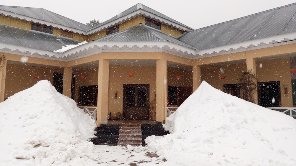 brown and white wooden house covered by snow during daytime