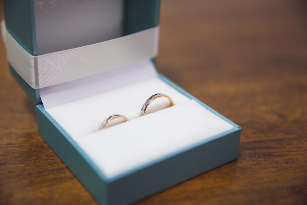 silver and gold rings in box