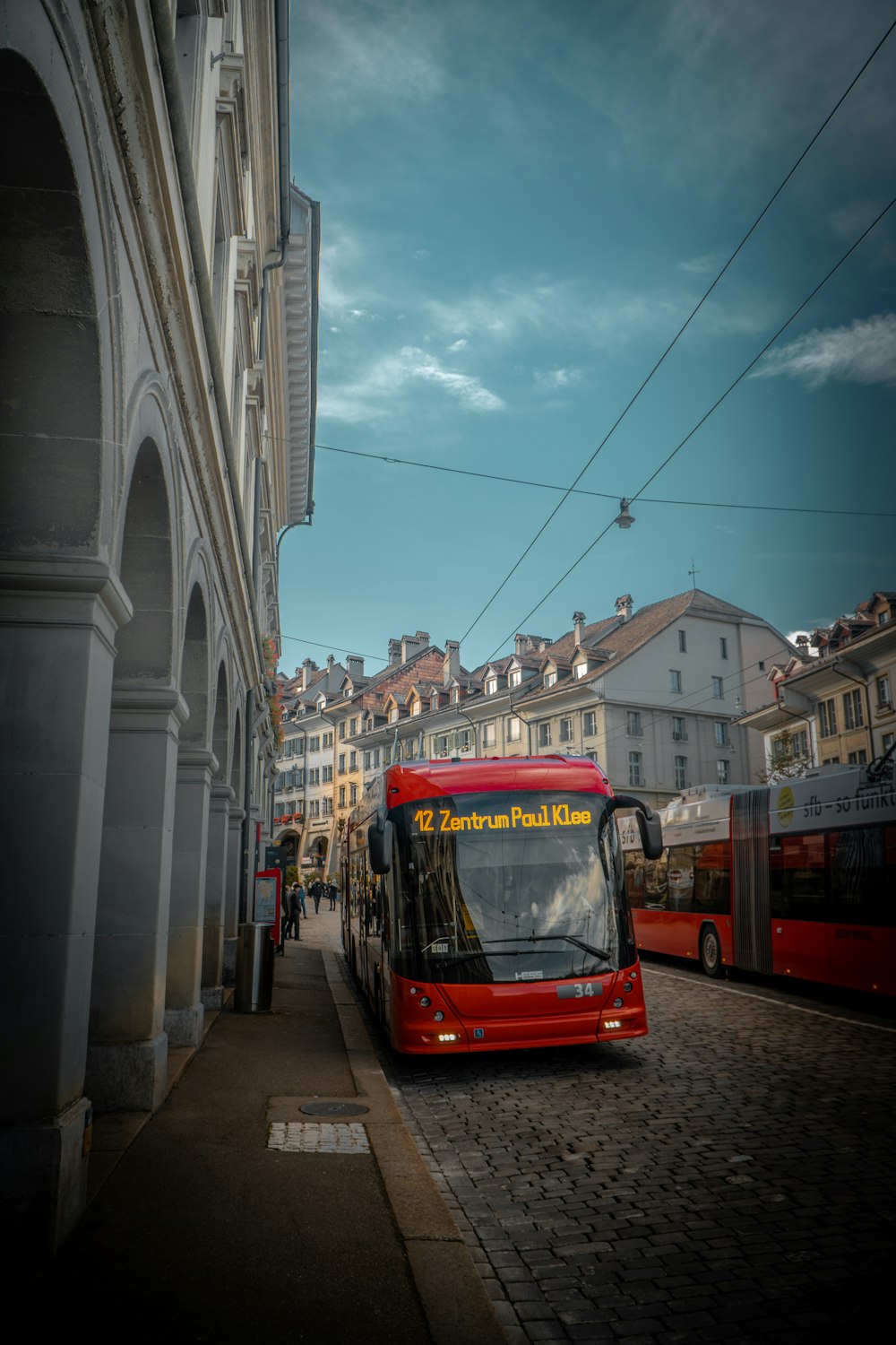 red tram in the city during daytime