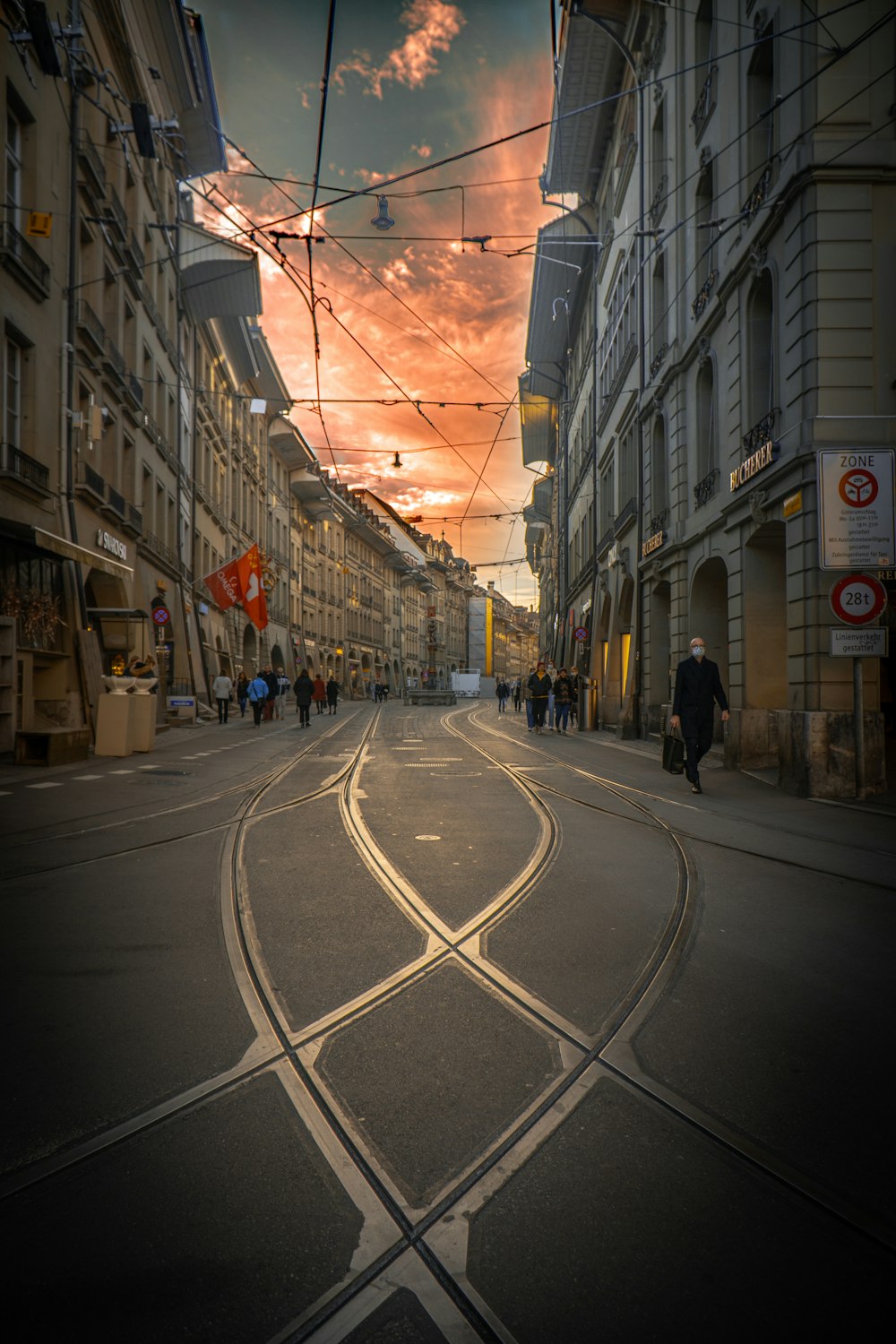 people walking on street between buildings during daytime