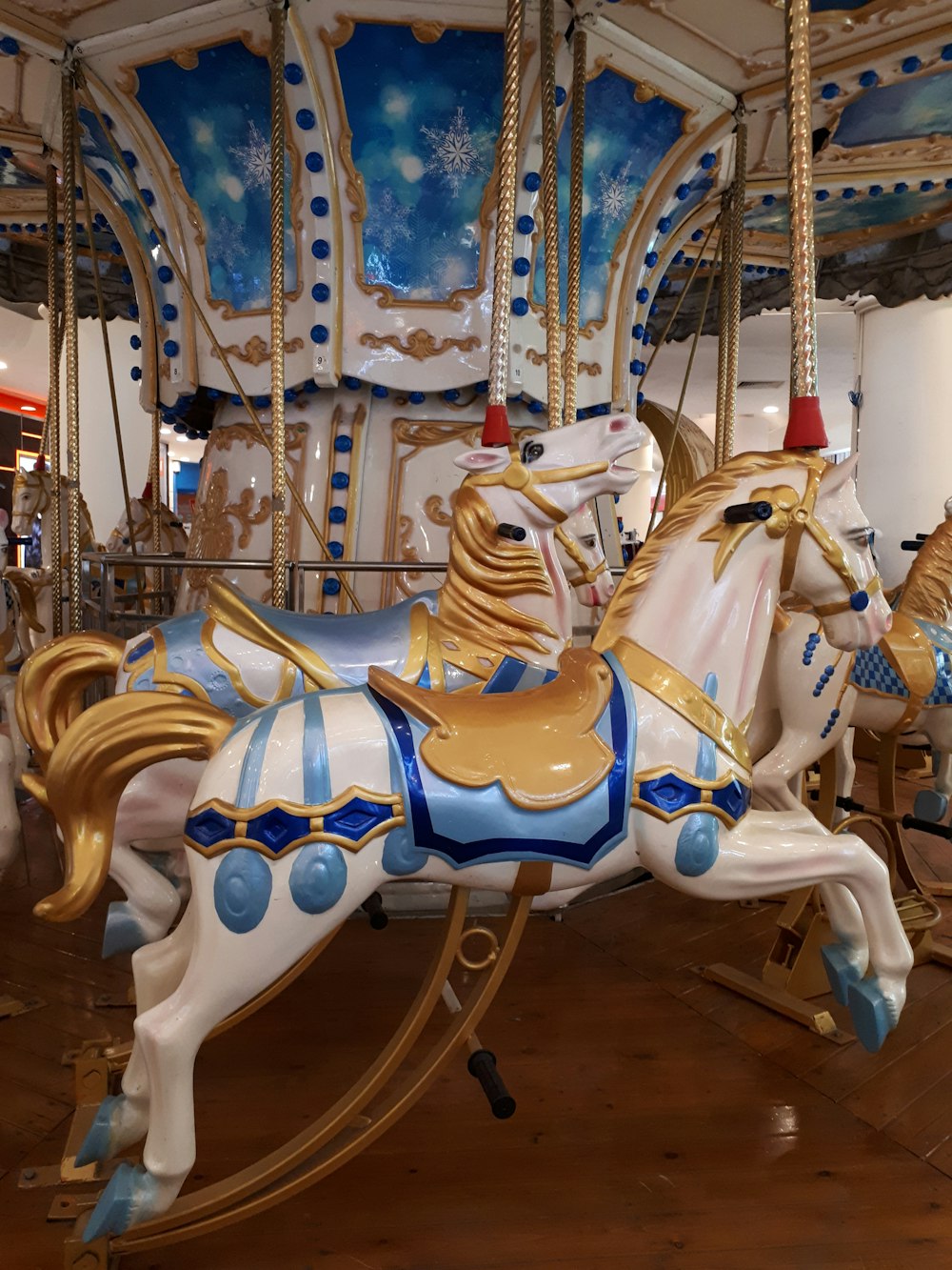 white and blue carousel horse