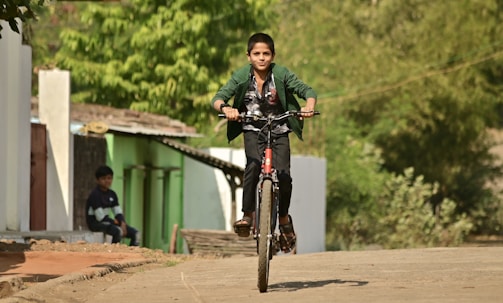man in black jacket riding bicycle during daytime