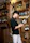 A knowledgeable sommelier recommending wines to a smiling couple in an elegant wine shop.
