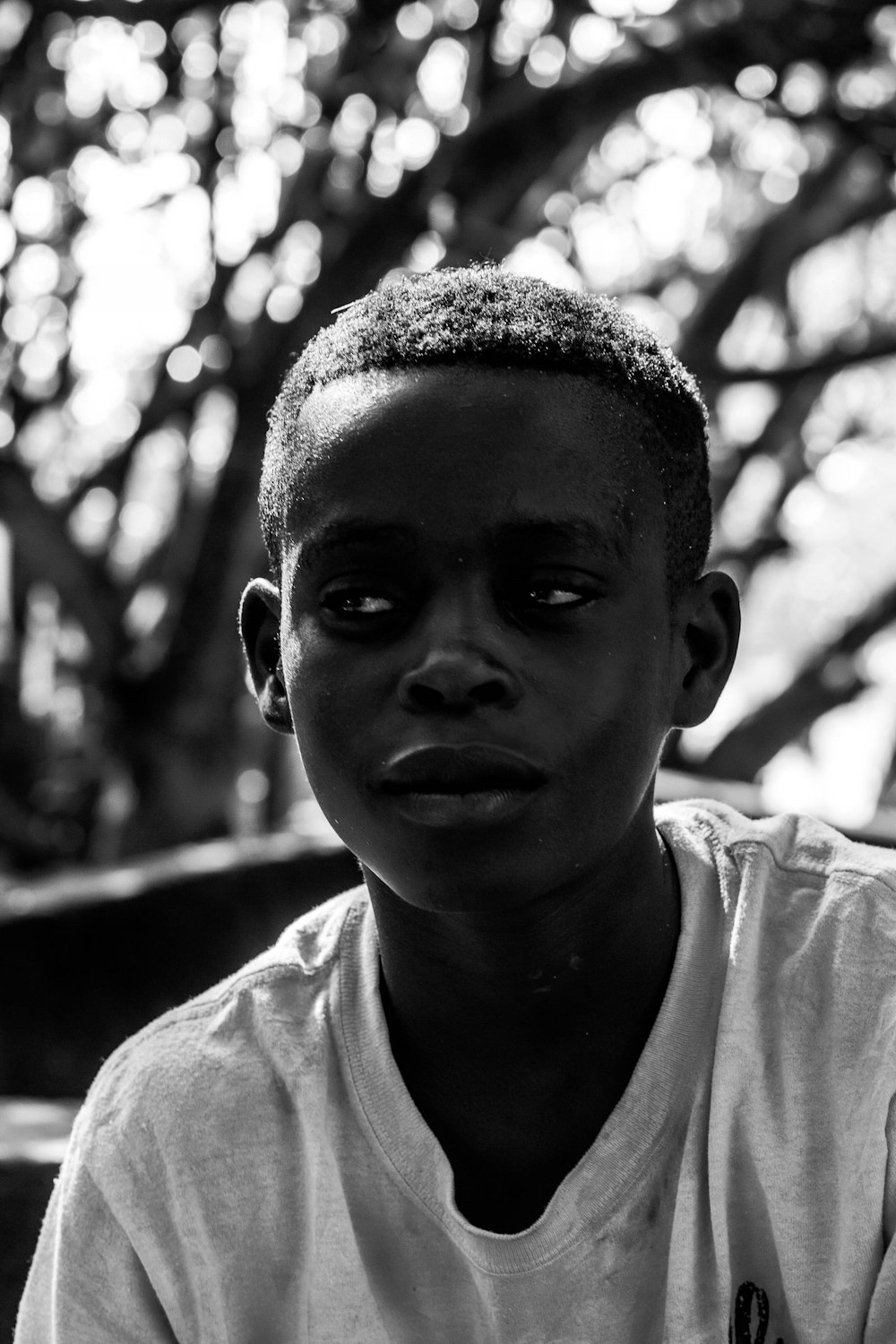 grayscale photo of boy in crew neck shirt