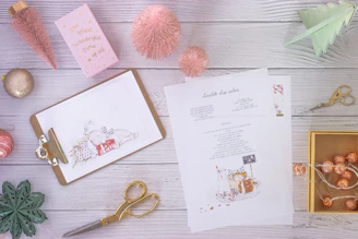 A colorful flat lay of printed event planning checklists with a pen and festive decorations