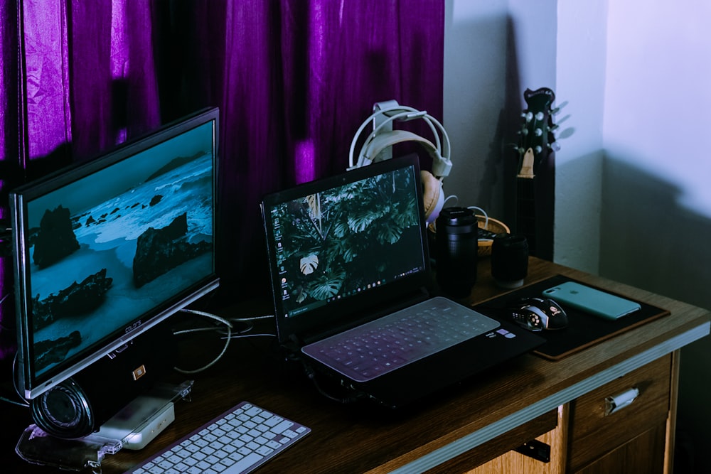 black laptop computer on brown wooden table