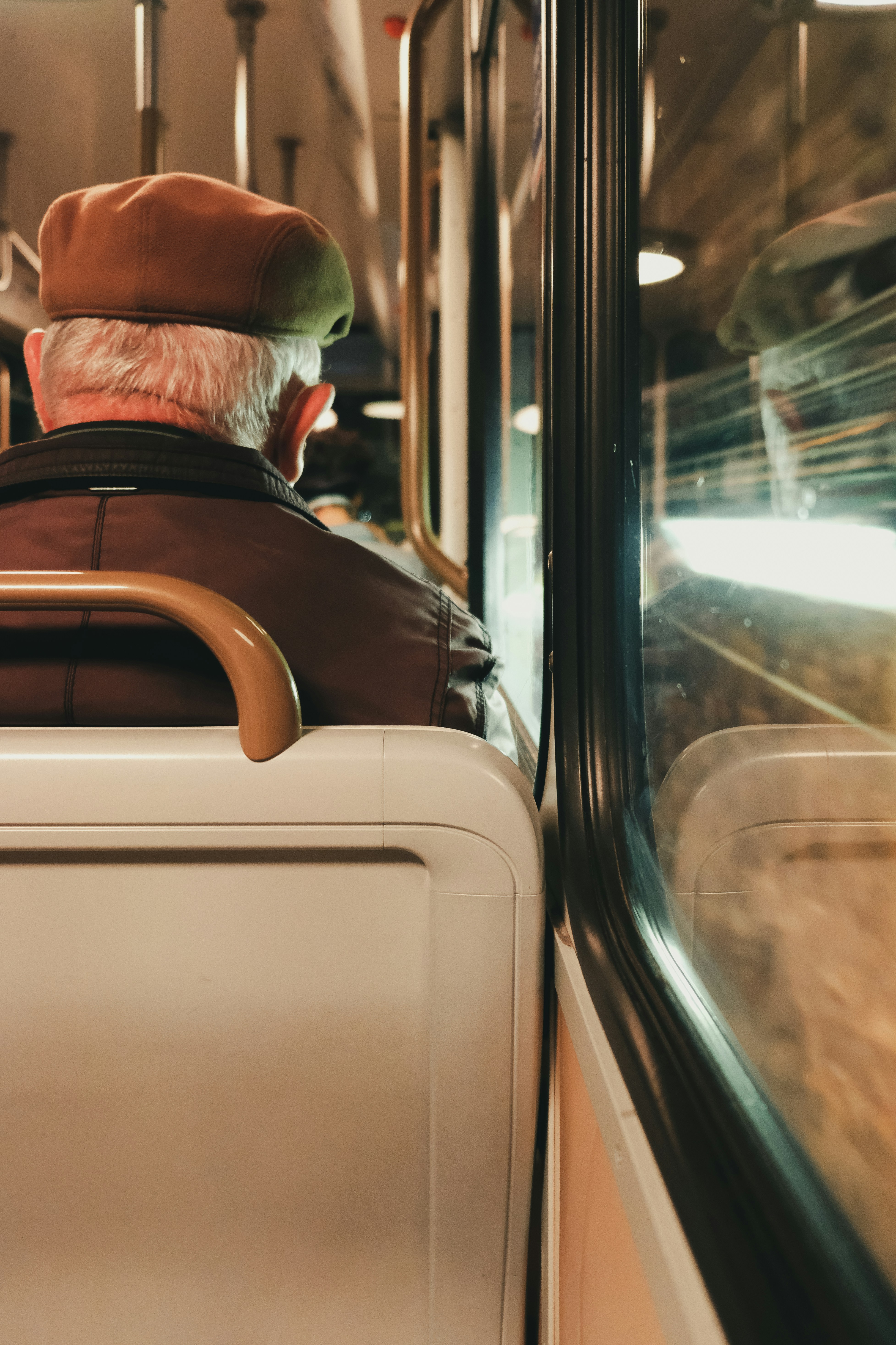 man in black jacket and green cap sitting inside car
