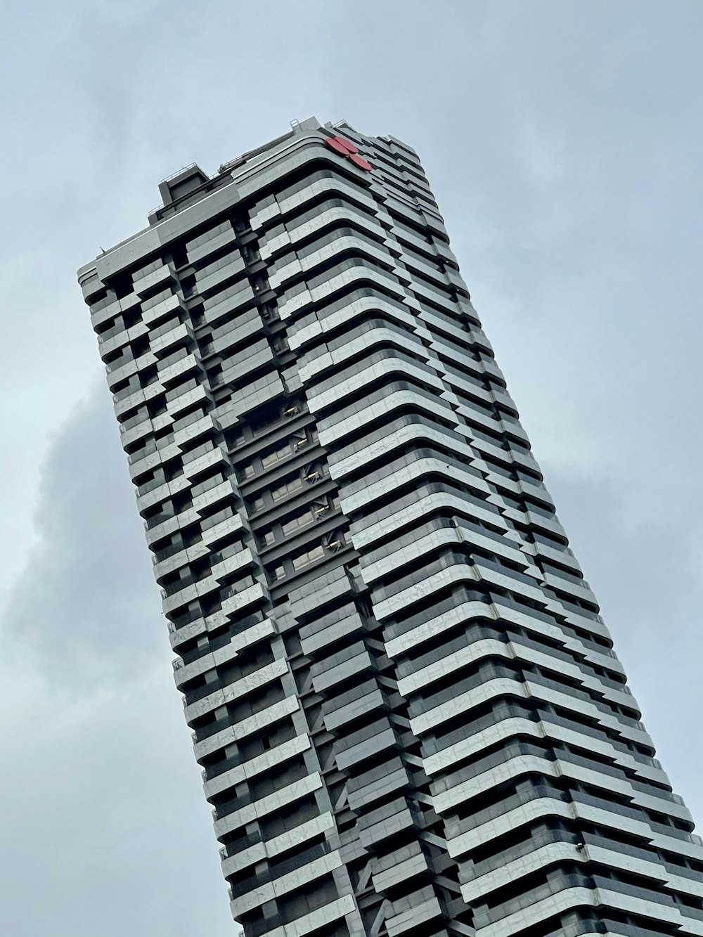 white and black concrete building under white clouds during daytime