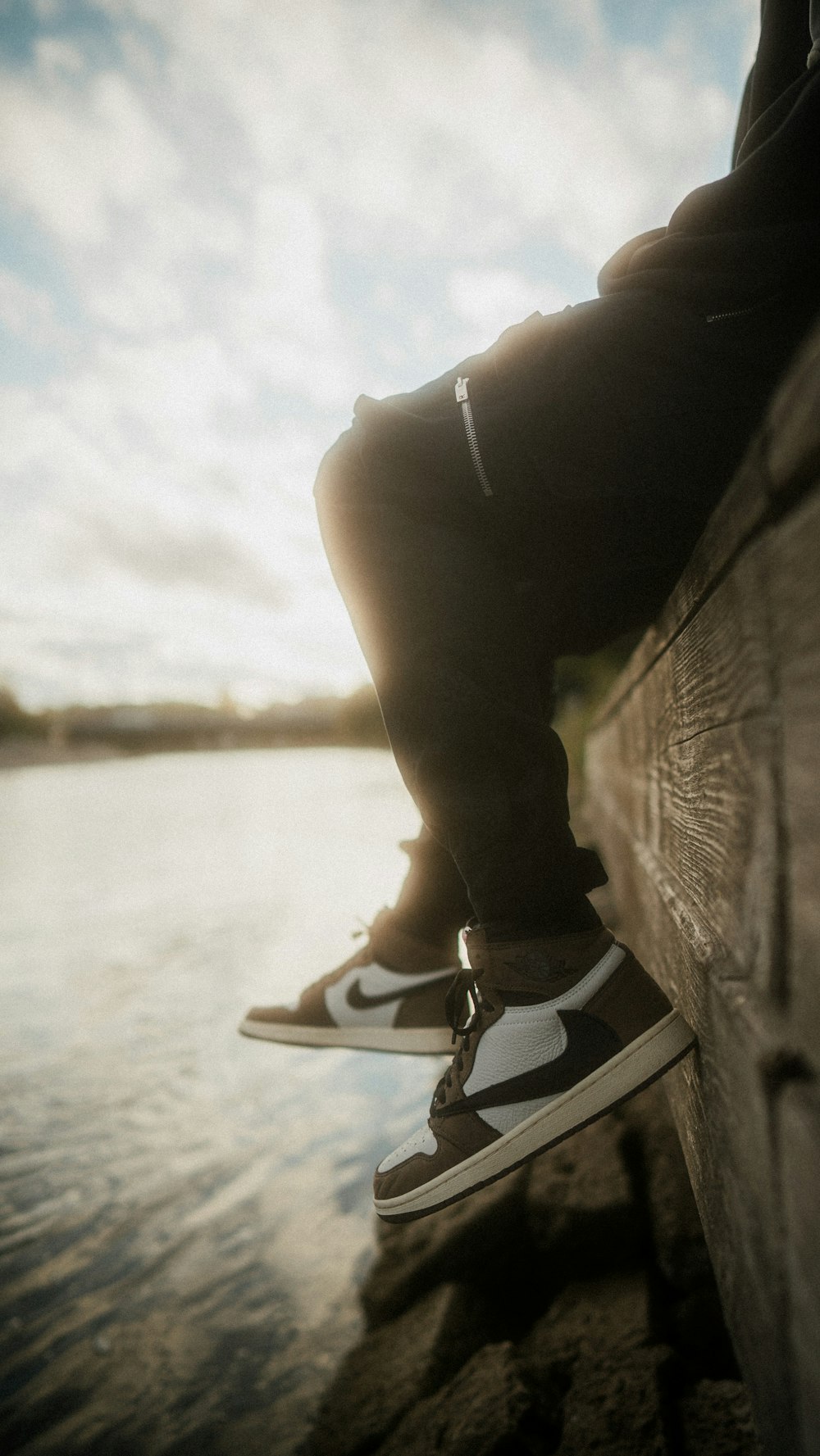 person wearing black and white converse all star high top sneakers