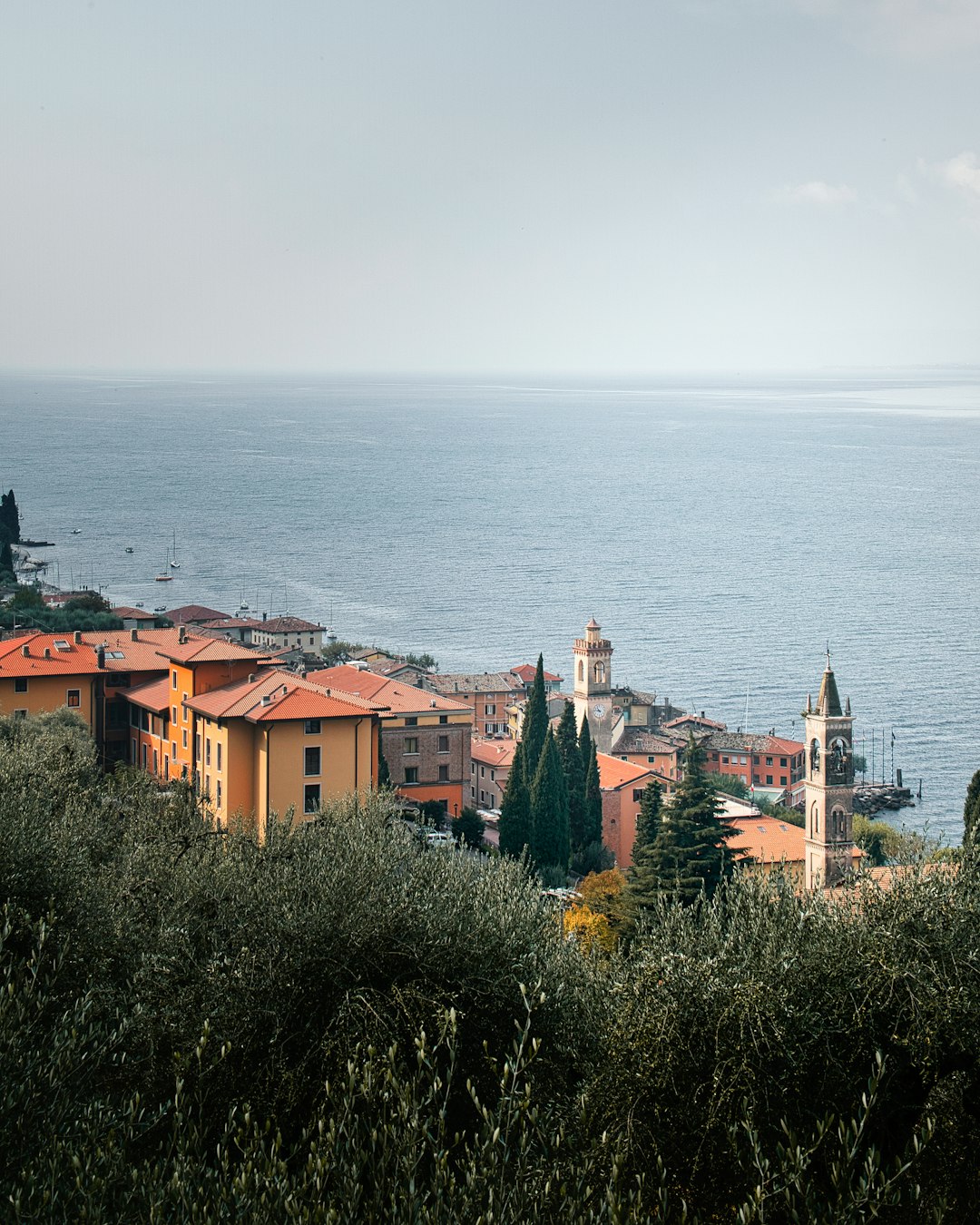 brown and white concrete houses near body of water during daytime