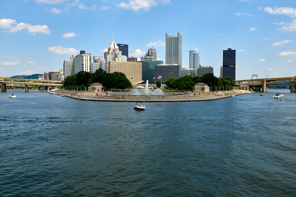 white boat on sea near city buildings during daytime