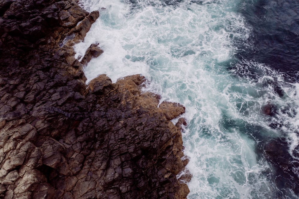 brown rocky shore with blue water