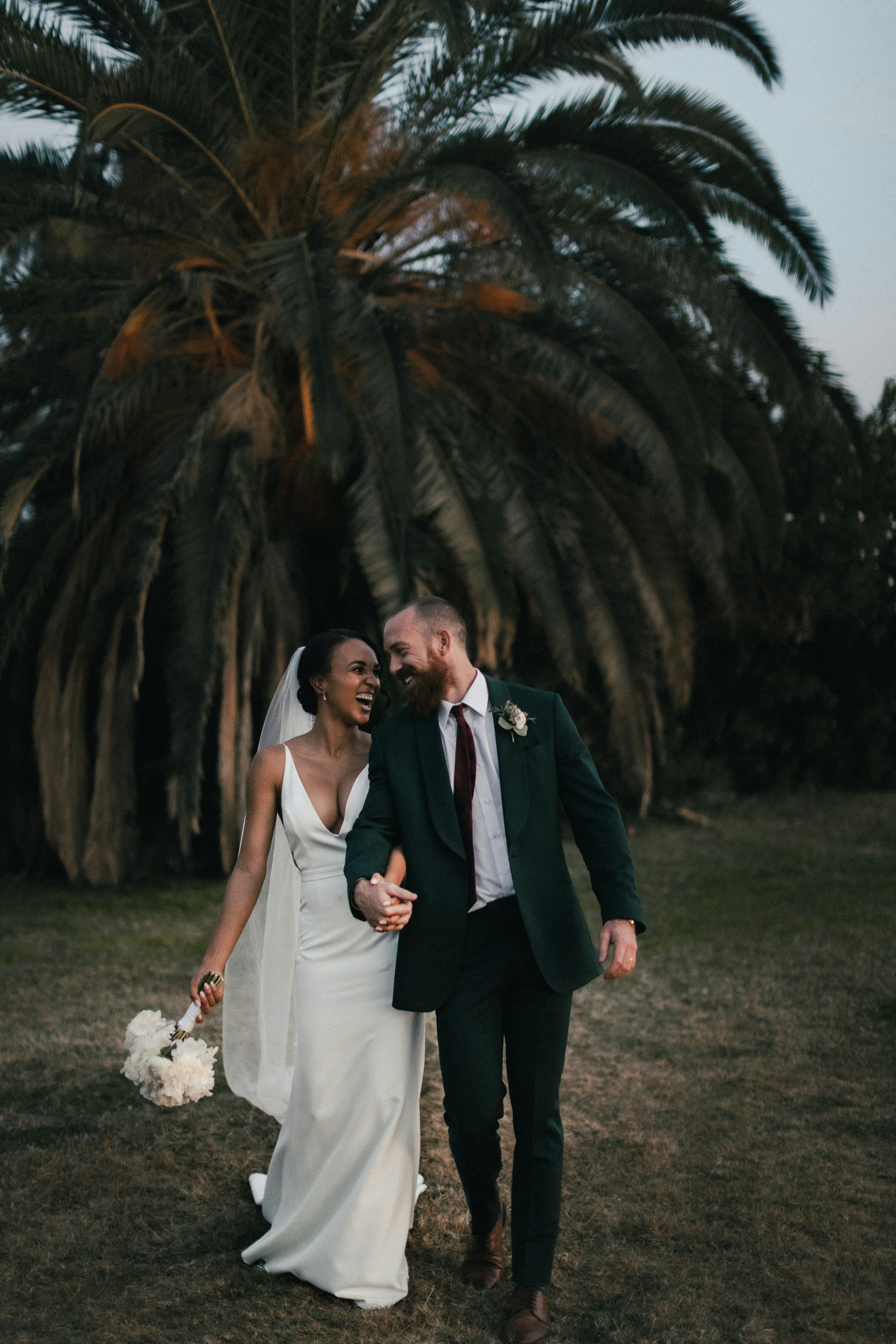Couple holding hands during their wedding ceremony, exchanging vows