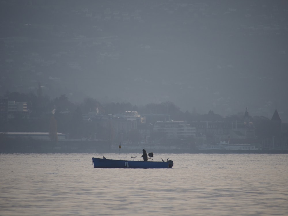 person riding on boat on body of water during daytime