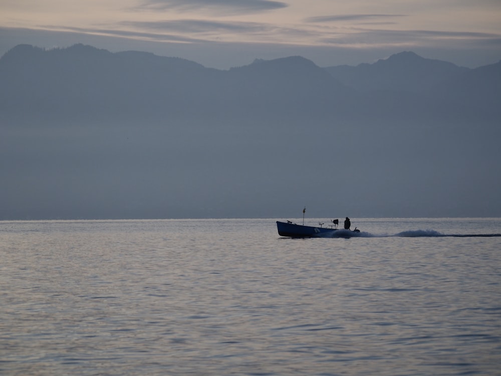 white boat on sea during daytime