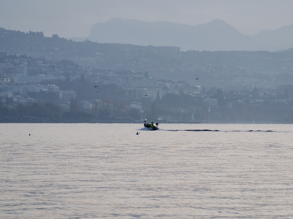 person riding on boat on sea during daytime