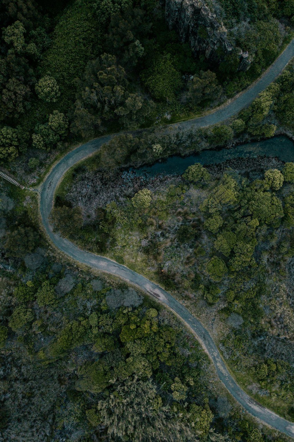 aerial view of road in the middle of green grass field