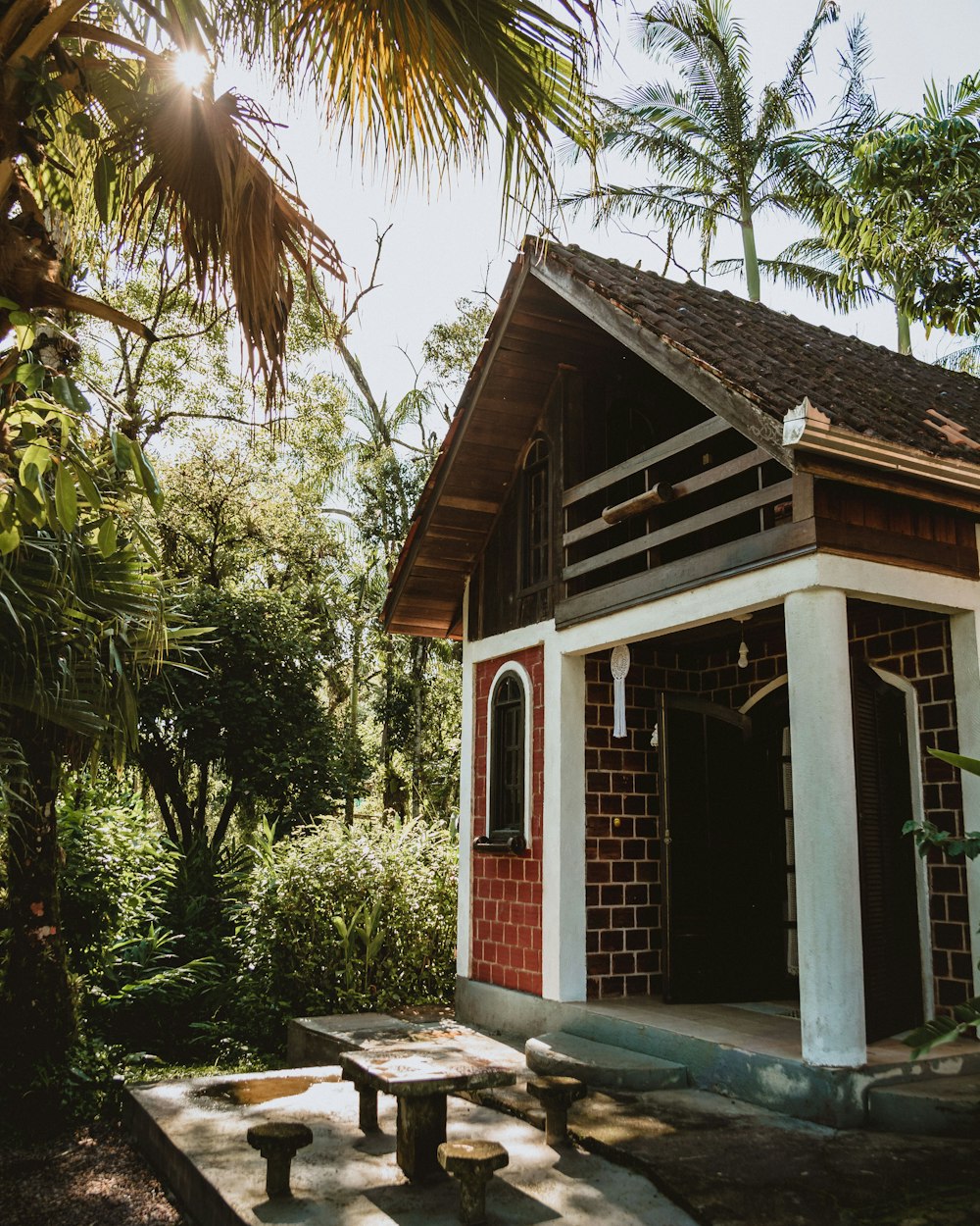 brown wooden house near green trees during daytime