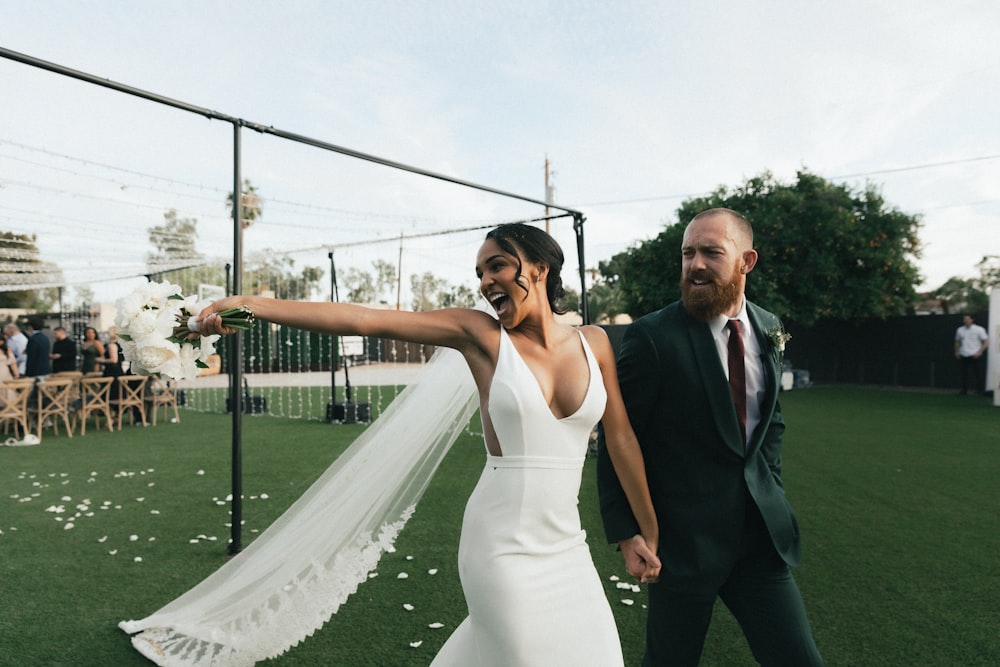 man in black suit jacket and woman in white dress