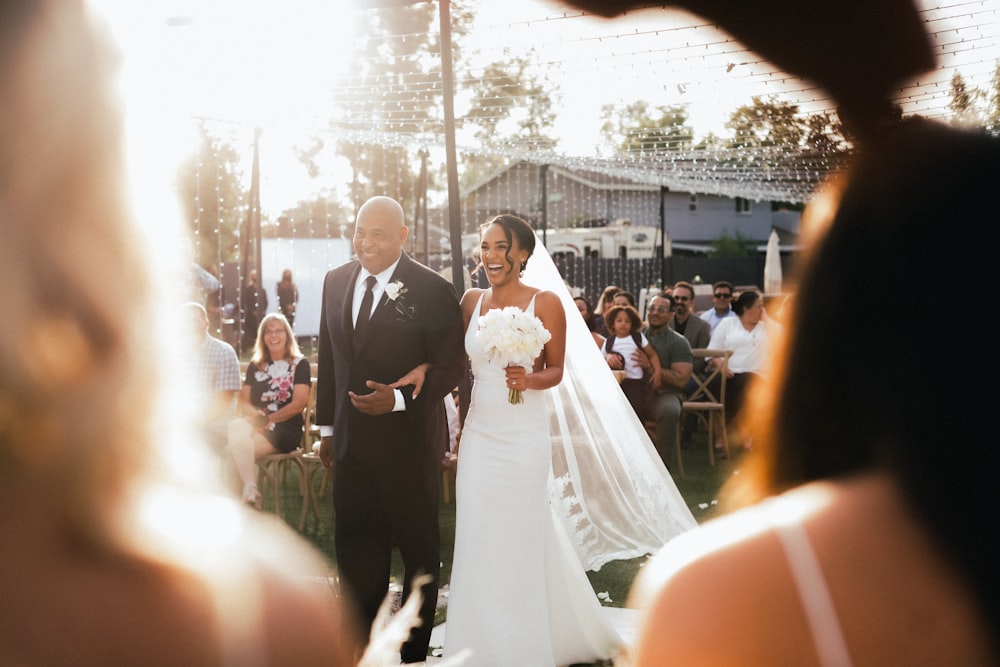 bride and groom standing on the street during daytime