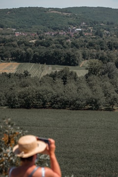 A person taking photos of a rural land parcel.