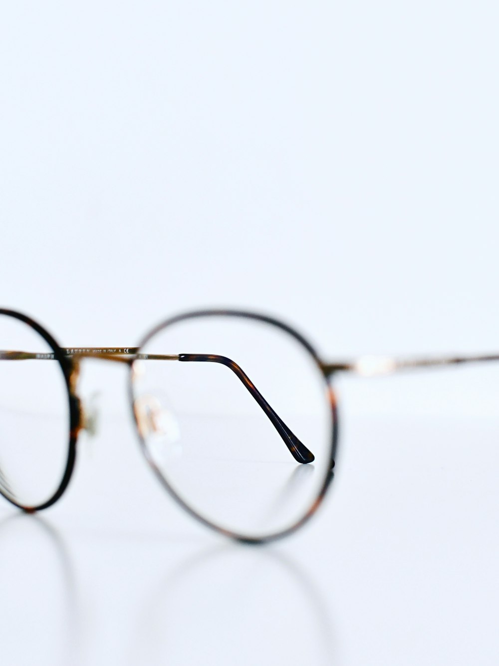 silver framed eyeglasses on white background